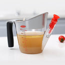 2-cup fat separator strainer with measuring marks and pour spout, perfect for separating fat from sauces and broths.