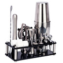 Premium stainless steel cocktail shaker set with various bartending tools organized on a stand.