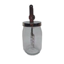 Hand butter blender vintage in a glass bottle with a metal lid and mixing tool, perfect for homemade butter.